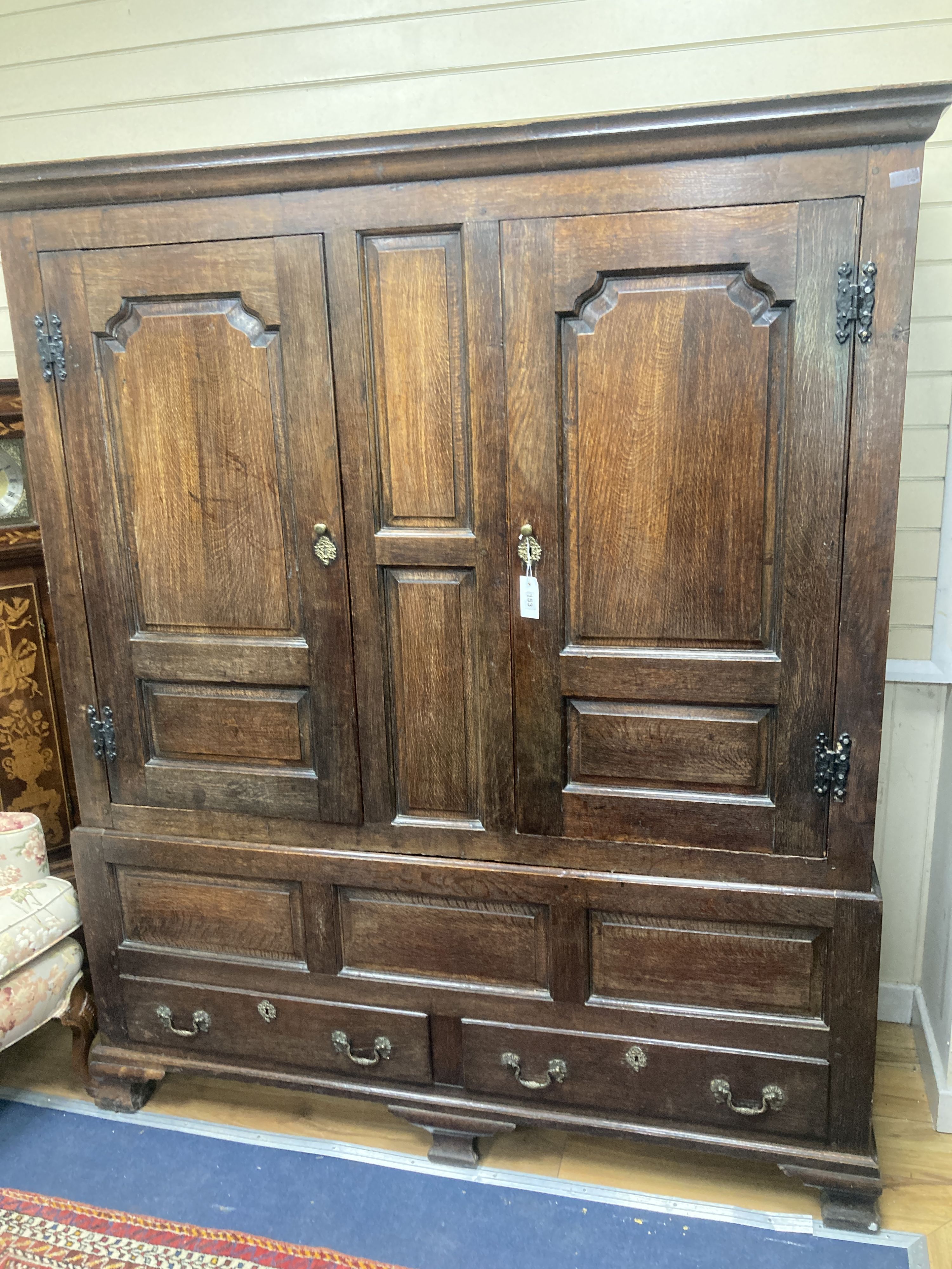 A mid 18th century oak panelled two part hanging cupboard, width 156cm, depth 53cm, height 188cm